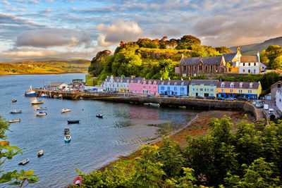 Scenic view of sea by buildings against sky