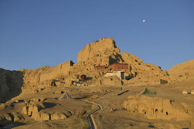 View of desert against clear blue sky