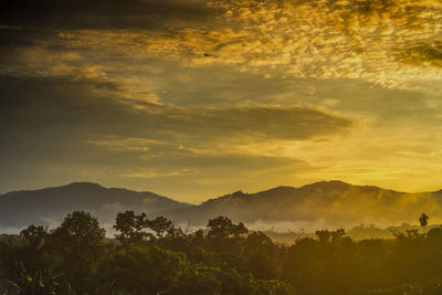 Scenic view of mountains against dramatic sky