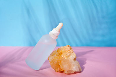 Close-up of hand holding ice cream on table