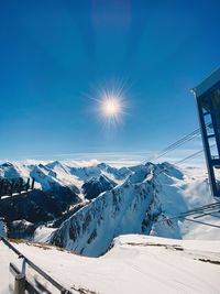Scenic view of snowcapped mountains against blue sky