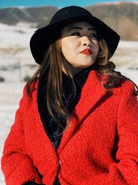 Woman wearing red coat during winter