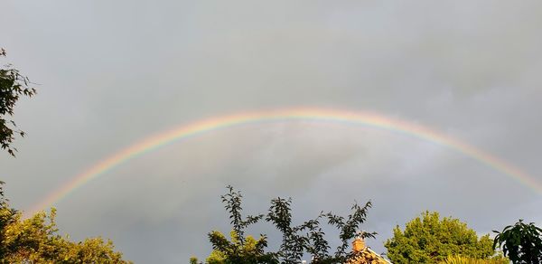 Low angle view of rainbow against sky
