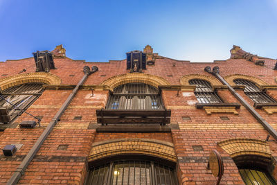 Low angle view of old building against clear blue sky