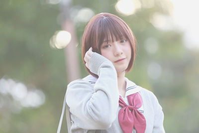 Portrait of young woman in school uniform