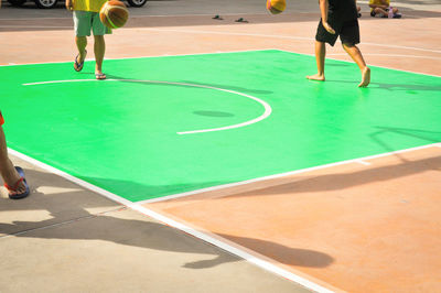 Low section of boys playing basket ball