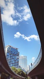 Low angle view of modern buildings against blue sky