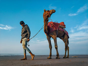 Traditional clothing standing on land against sky