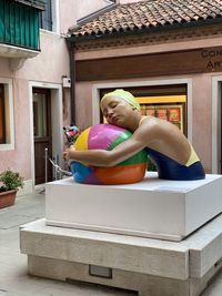 Woman sitting on a building