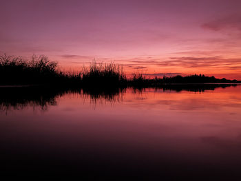 Scenic view of lake against romantic sky at sunset
