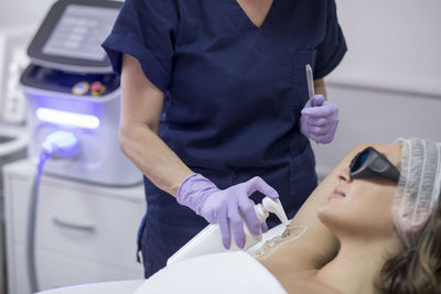 Female doctor operating patient during beauty treatment