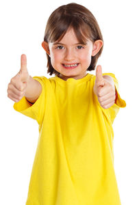 Portrait of smiling girl standing against white background