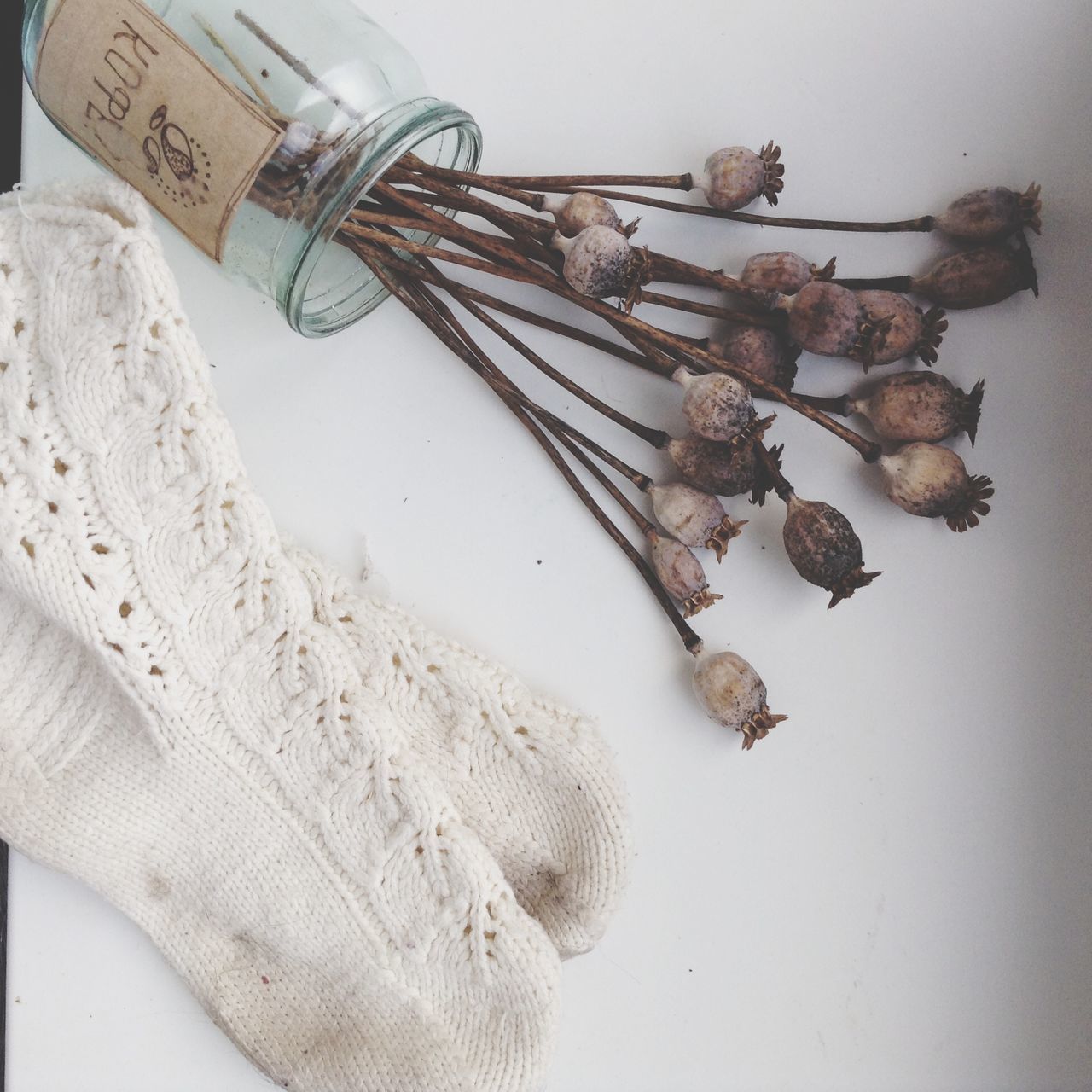 indoors, still life, close-up, high angle view, wall - building feature, no people, wood - material, white color, metal, wall, old, table, hanging, directly above, paper, brown, day, built structure, communication, white