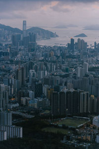 Aerial view of buildings in city against sky