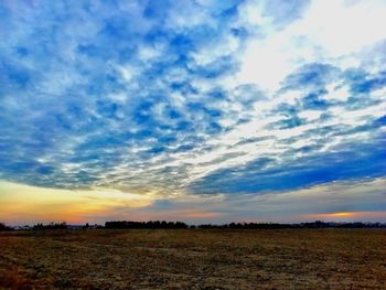 Scenic view of field against sky during sunset