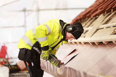 Woman working on roof