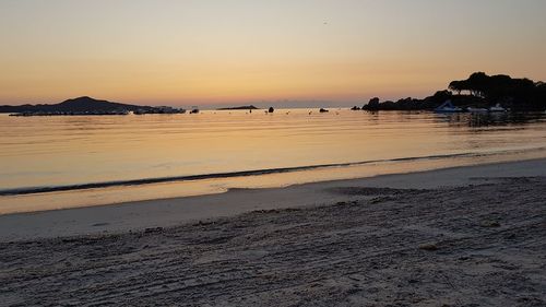 Scenic view of sea against clear sky during sunset