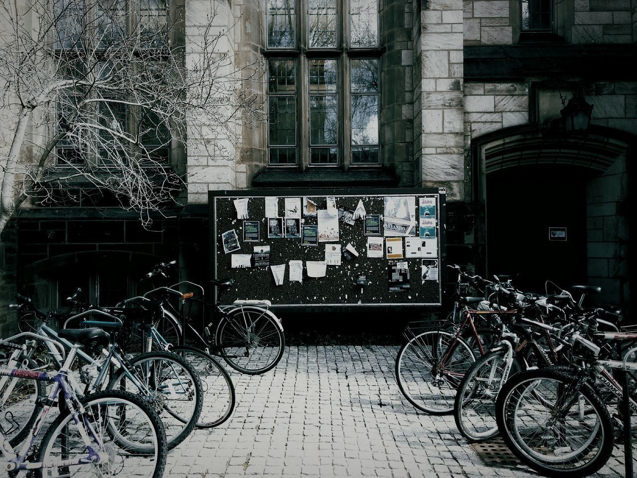 BICYCLE PARKED AGAINST BUILDING