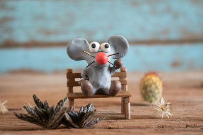 Rat from plasticine,cartoon style.the background is blue wood panels.