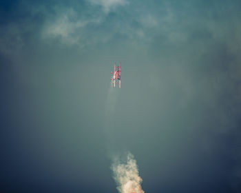 Airplane flying over water against sky