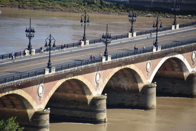 Arch bridge over river in city