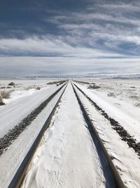 Snow covered road against sky