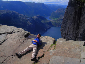 Full length of hiker lying on preikestolen