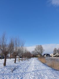 Snow covered field against clear sky