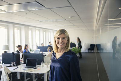 Portrait of team leader standing in office