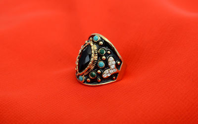 Close up of ring against red background