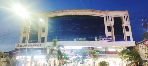 Low angle view of illuminated building against blue sky