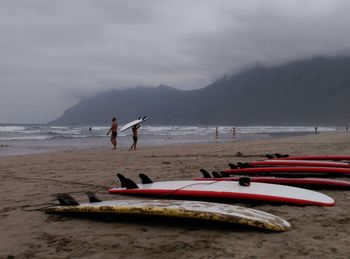 People on beach against sky