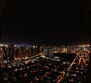 High angle view of illuminated cityscape against sky at night