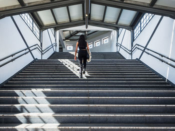 Low angle view of woman on staircase