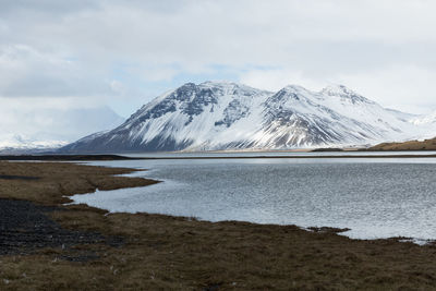 Scenic view of lake and mountains against sky