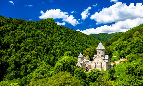 Panoramic view of trees and buildings against sky