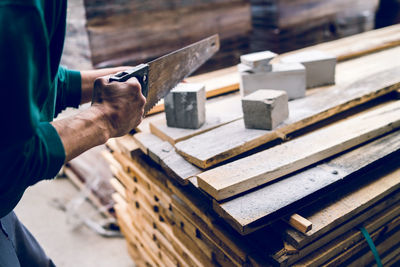 Midsection of man working on wood