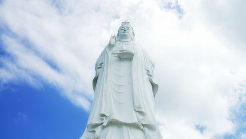 Low angle view of statue against cloudy sky