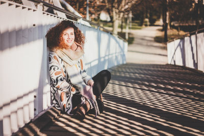 Full length of woman standing on footbridge