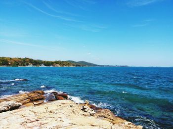 Scenic view of sea against blue sky