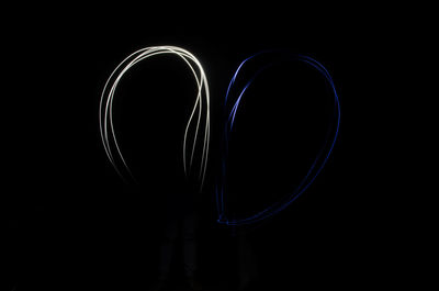 Close-up of illuminated lighting equipment against black background