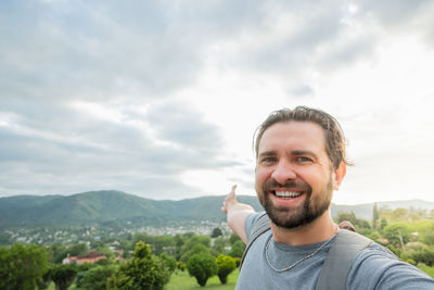 Portrait of young man against mountain