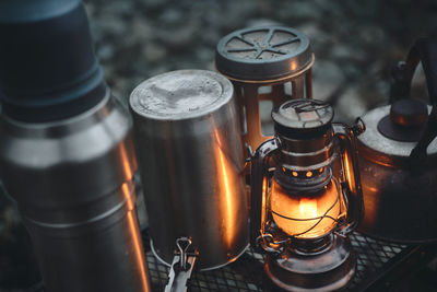 Camping gear illuminated by lanterns.