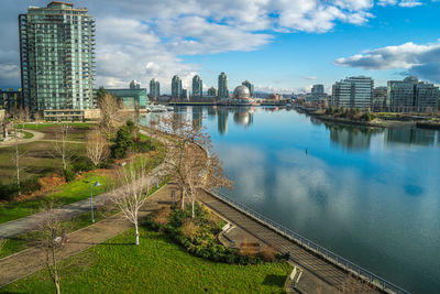 Cityscape at false creek against sky