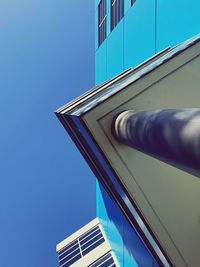 Low angle view of modern building against clear blue sky