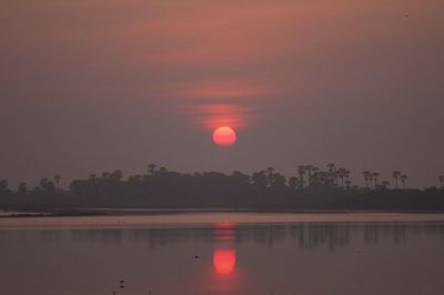 Scenic view of lake against sky during sunset