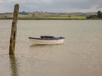 Boat moored in calm lake