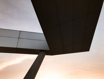 Low angle view of built structure against cloudy sky during sunset