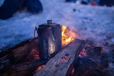 Close-up of fire on log at night