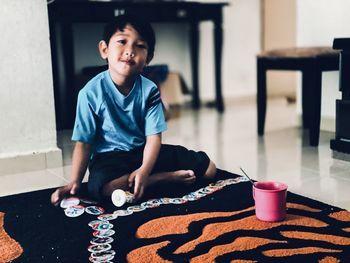 Portrait of boy sitting at home